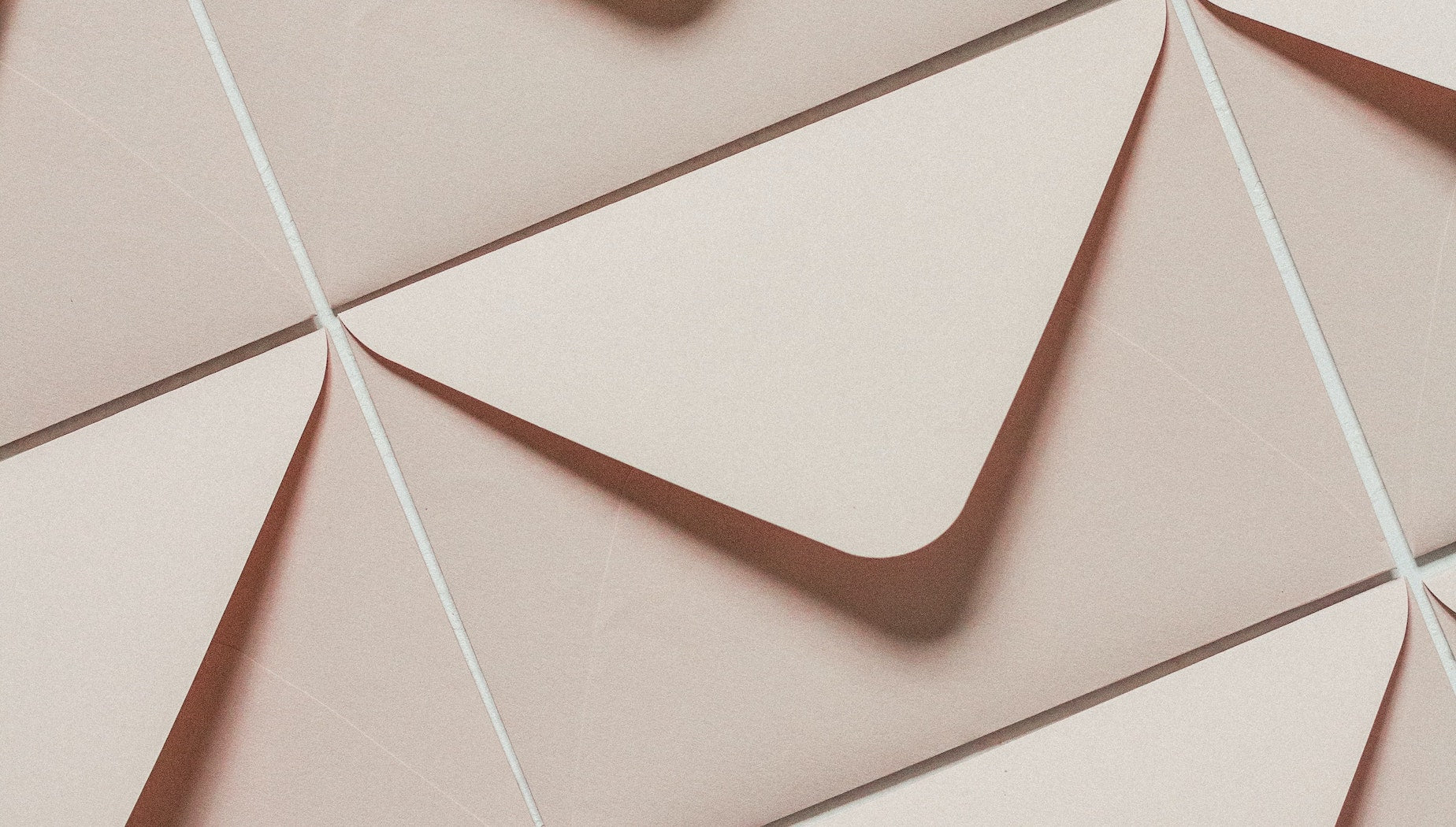 A flat lay of identical beige envelopes